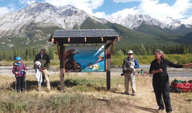 Ruthie Oltmann, far left of sign, at a new kiosk regarding the eagle migration in Kananaskis Country. Joining Oltmann for the unveiling was Don Carruthers Den Hoed, left,