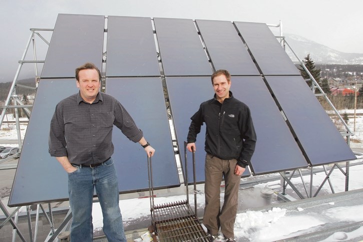 Lloyd Smith, left, tragically killed in an amonia leak at a Fernie rink was pictured next to solar panels at the Canmore Rec Centre during his time as the Town of Canmore