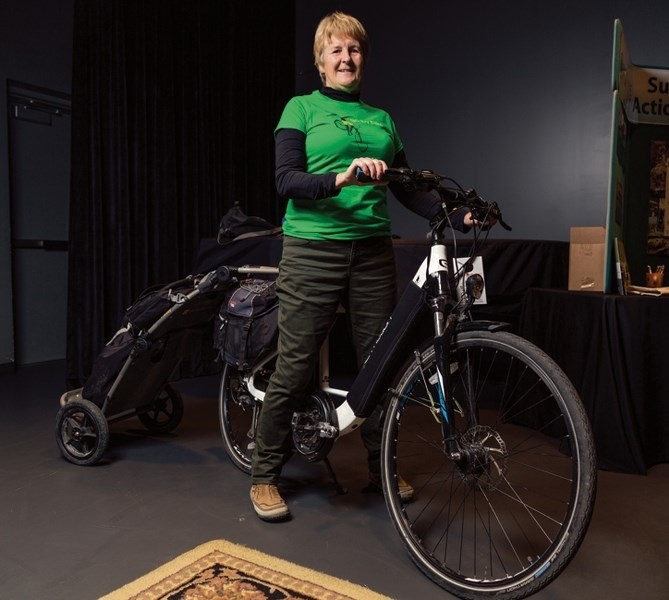 Mandy Johnson sits on her pedal assist electric bike at artsPlace in Canmore on Sunday (Oct. 29). The Biosphere Institute put on an afternoon of learning about e-bikes,