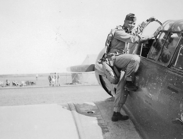 Cliff Hansen in his early air force days climbing into the cockpit of a Harvard trainer.