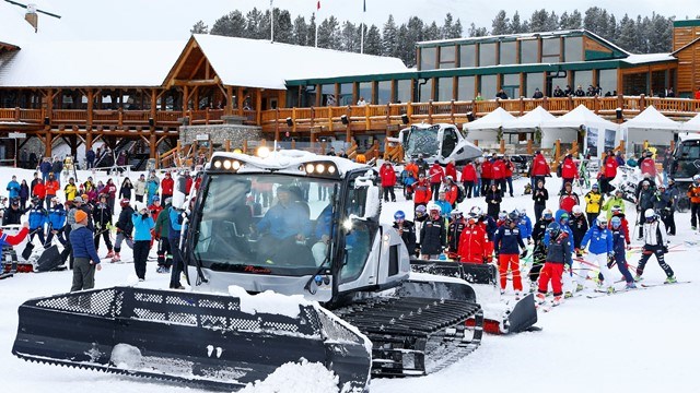 A Prinoth snow-groomer prepares to tow racers and officials with the 2017 Audi FIS Ski World Cup to the start of the race course at Lake Louise ski hill after a power outage