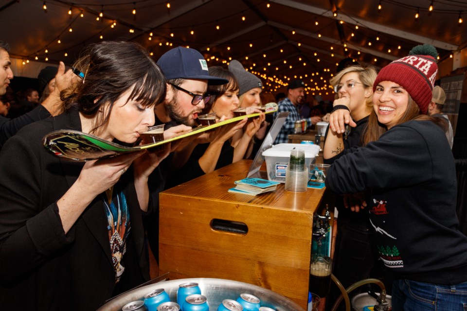 Guests have a drink from the Banff Ave. Brewing shot-ski at the Banff Craft Beer Festival at the Cave and Basin on Saturday (Nov. 23). CHELSEA KEMP RMO PHOTO