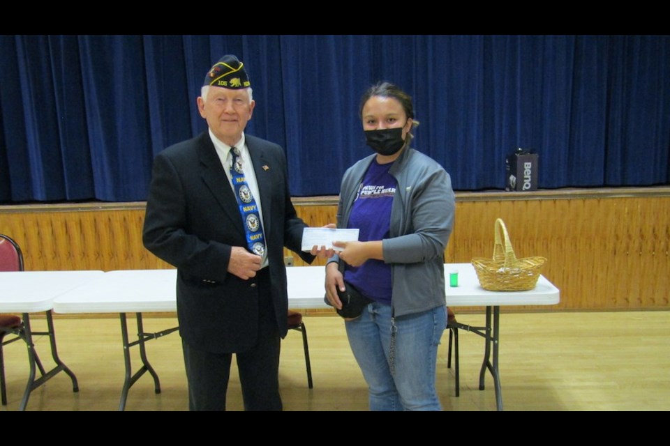 Legion finance officer Vernon Mull presents a $1,000 donation to PPH program instructor Megan Franke. 