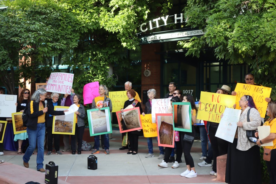 Organizers with Faith In Action stand outside of City Hall on June 27, 2023. By Avery Luke.