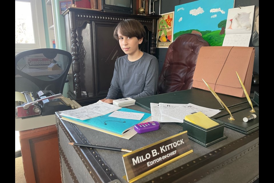 Hamster News editor-in-chief Milo Kittock sits behind his desk