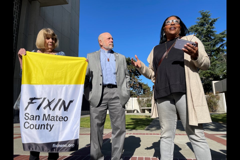 Members of Fixin' San Mateo County rally outside the Hall of Justice before the County Board of Supervisors meeting