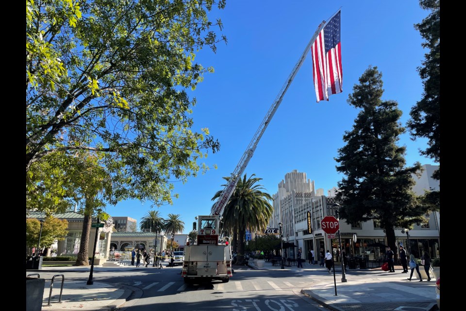 The Redwood City Fire Department raises a flag over Courthouse Square