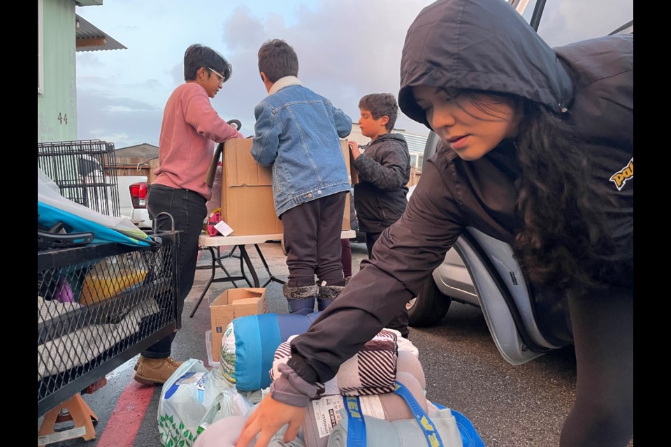 Volunteers organize donations to hand out to the residents of the R.C. Mobile Park