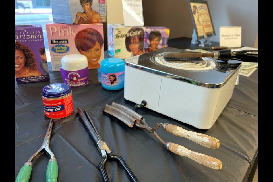 Black hair care products from throughout the years, including curling and straightening irons