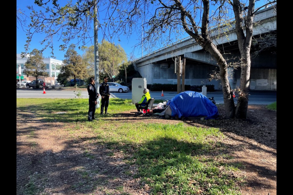 Two California Highway Patrolmen speak with Kyle Kotter, a homeless veteran