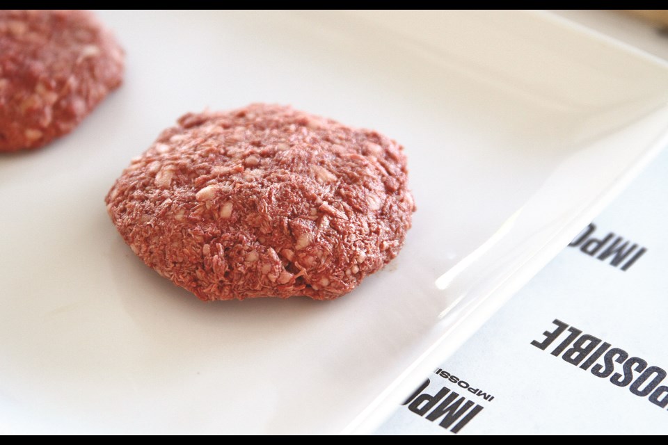 The Impossible Burger in its raw form reveals the blood-red color of the burgerâs signature ingredient, âhemeâ, a protein which gives ground beef burgers their signature taste, yet also exists in plants.  Impossible Foods extracts heme from fermented yeast.  