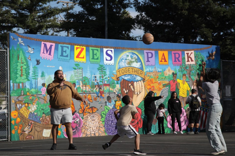 Kep Taimani, left, and his family play basketball in Mezes Park Friday, Nov. 10. Photo by Nicholas Mazzoni