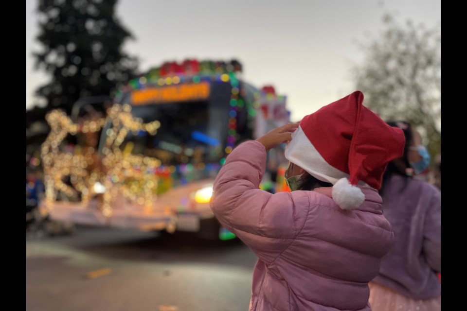 A young girl watches the SamTrans holiday bus