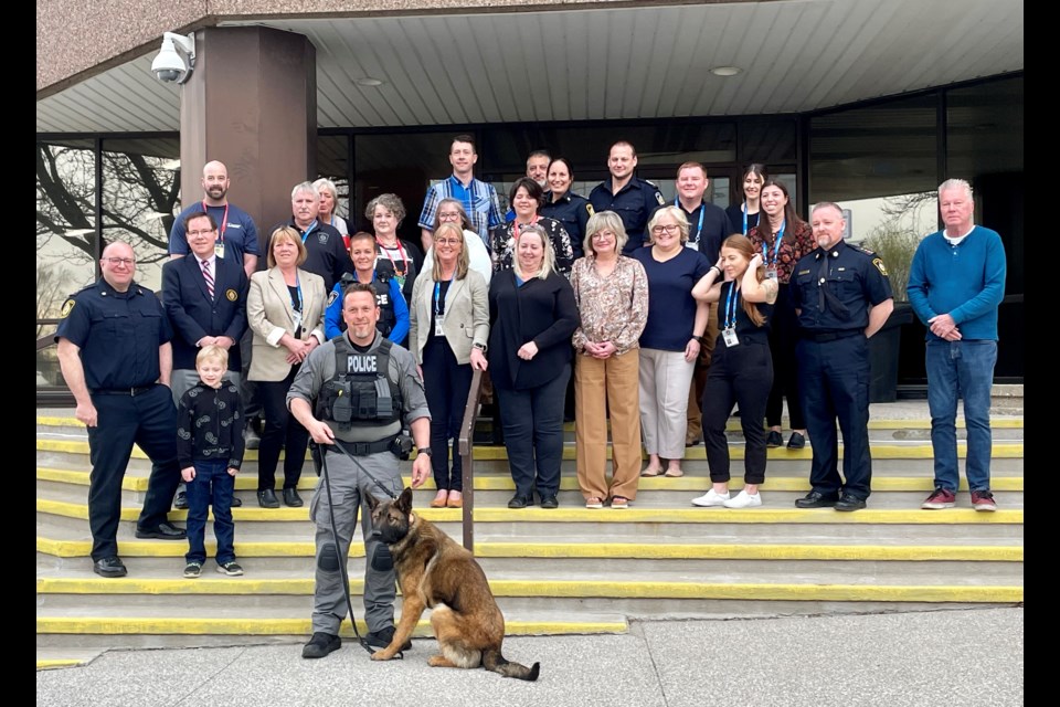 Sarnia Police board members, officers and staff outside headquarters this morning with Vader, the new police dog who leaves for training today.