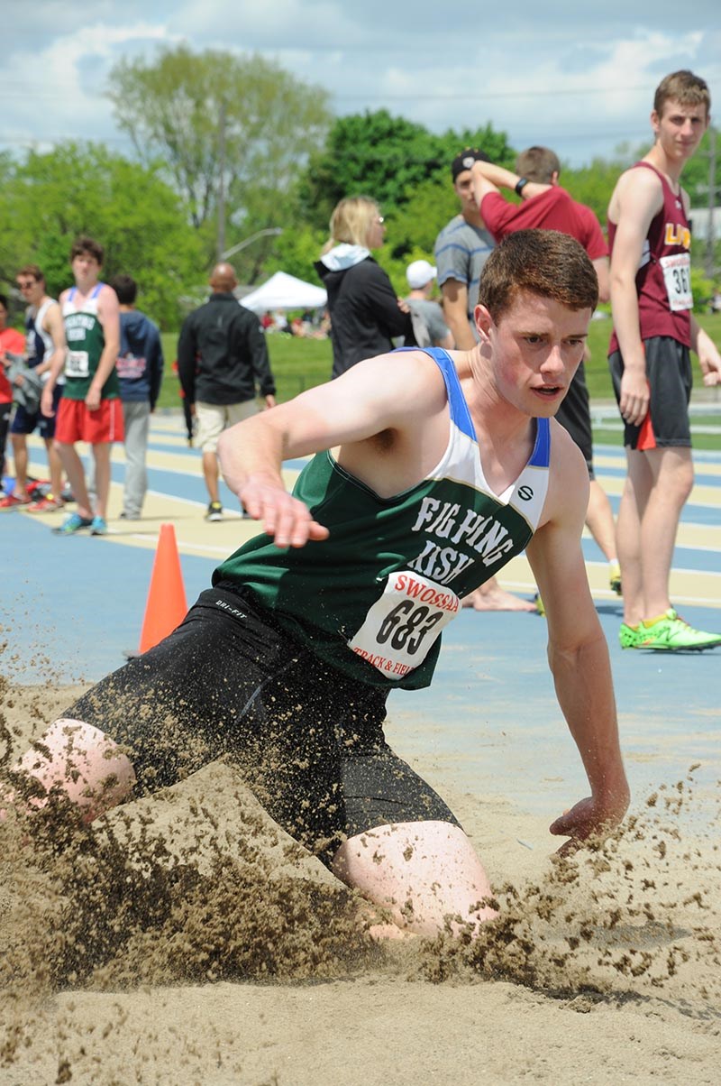 Cormac Brown of St. Patrick’s sends up a spray of sand in long jump at the SWOSSA track and field championships at the University of Windsor. Brown nailed a jump of 6 metres and 84 centimetres to win the senior boys event and advance to the Ontario regionals. Sharon O'Brien Photo
