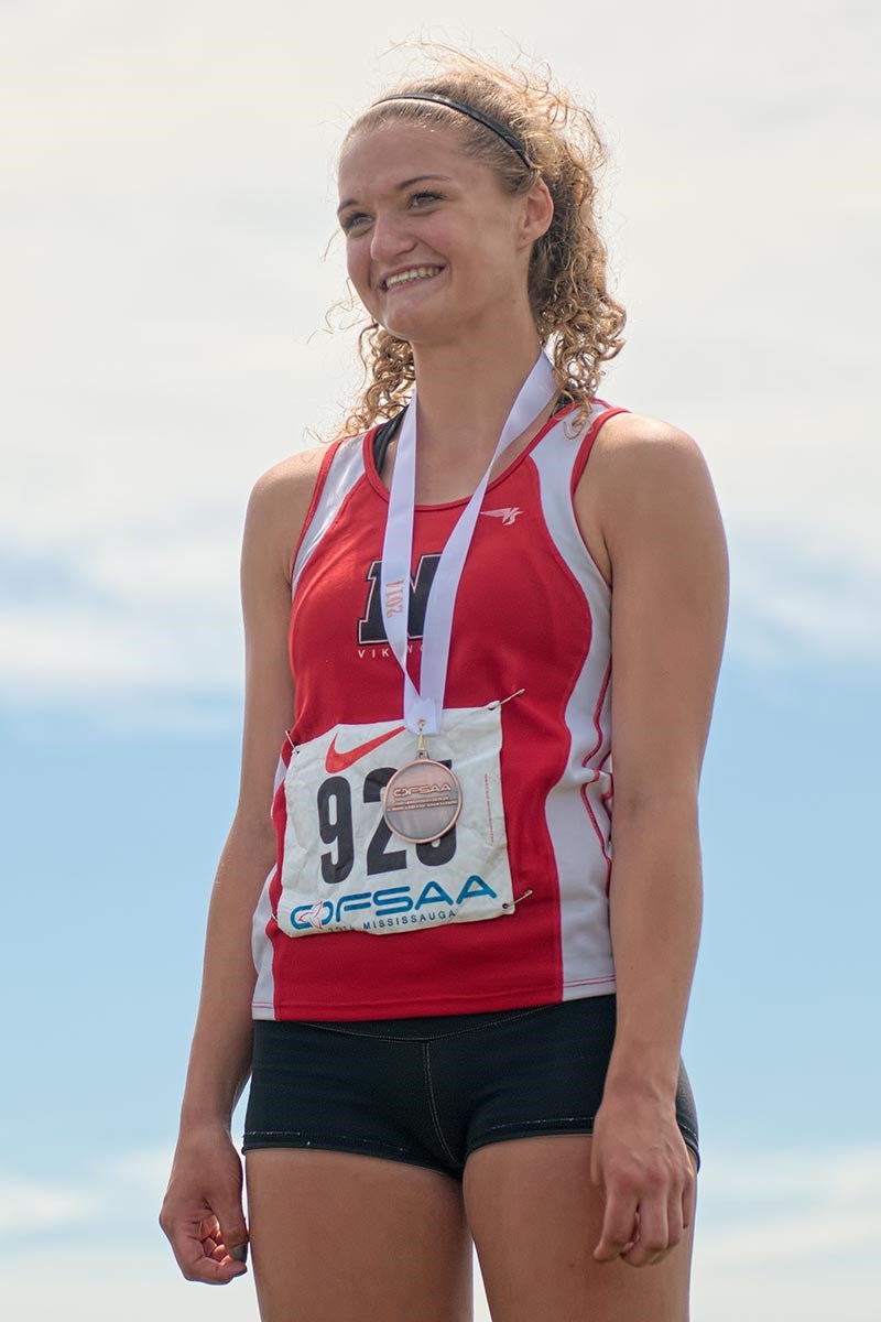 Kelly Hodgins of Northern Collegiate proudly wears the bronze she won in 80 metre hurdles. Bruce Smith Photo