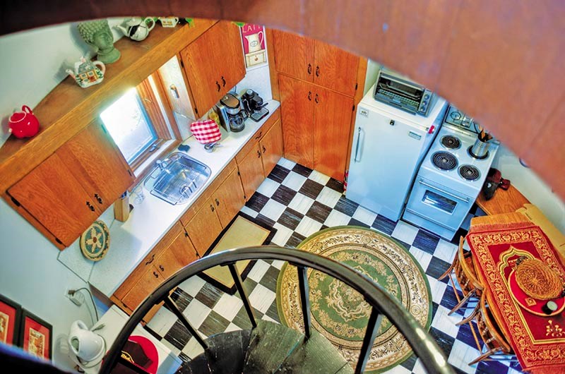 The kitchen cupboards and counter are custom built to match the home's curving walls. Glenn Ogilvie