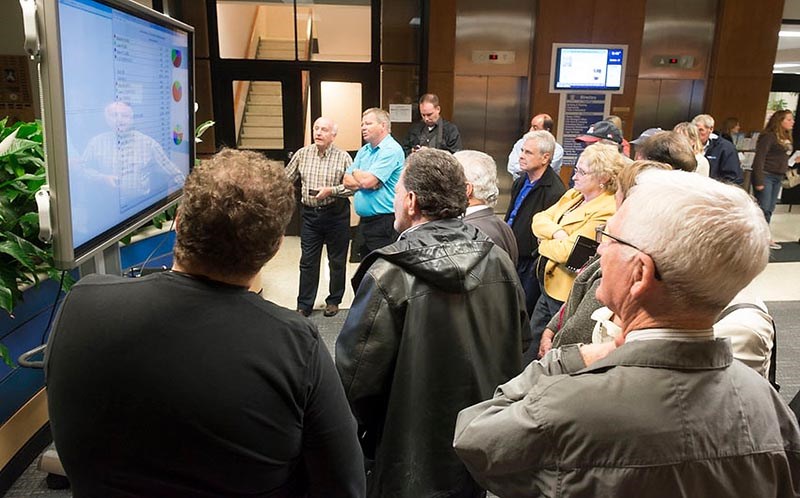 A small crowd watches the election results roll in Monday night at Sarnia city hall. Glenn Ogilvie