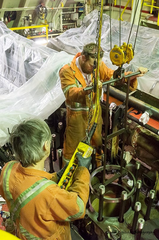 Algoma Central's Don Reashore, left, and Mark Lunn work on an engine piston deep in the bowels of the Algoma Olympic, a Canadian cargo carrier. Glenn Ogilvie