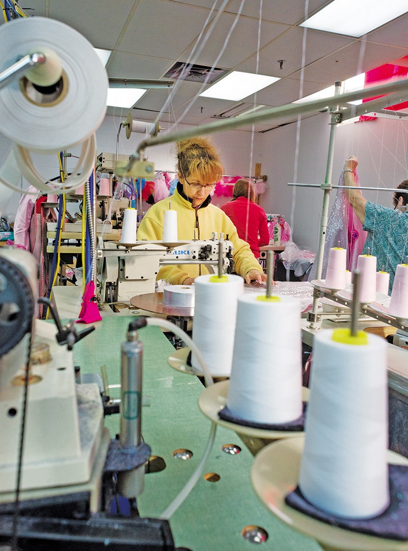 Seamstress Maria Moniz stitches a costume on the line at Great Pretenders manufacturing centre in Point Edward. Glenn Ogilvie