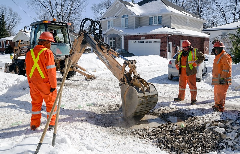 A City of Sarnia public works crew contends with a frozen water main. From left are Will Marut, James Smith and Roger Chedore. In the backhoe is Jeremy Hull. Glenn Ogilvie