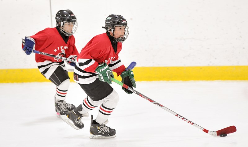 Stanley MacDonald of the Aamjiwnaang Jr. Hitmen leads the rush with teammate Tyler Andre trailing during the Atom A championship final of the Little Native Hockey League tournament in Mississauga, the largest in Canada. Submitted Photo
