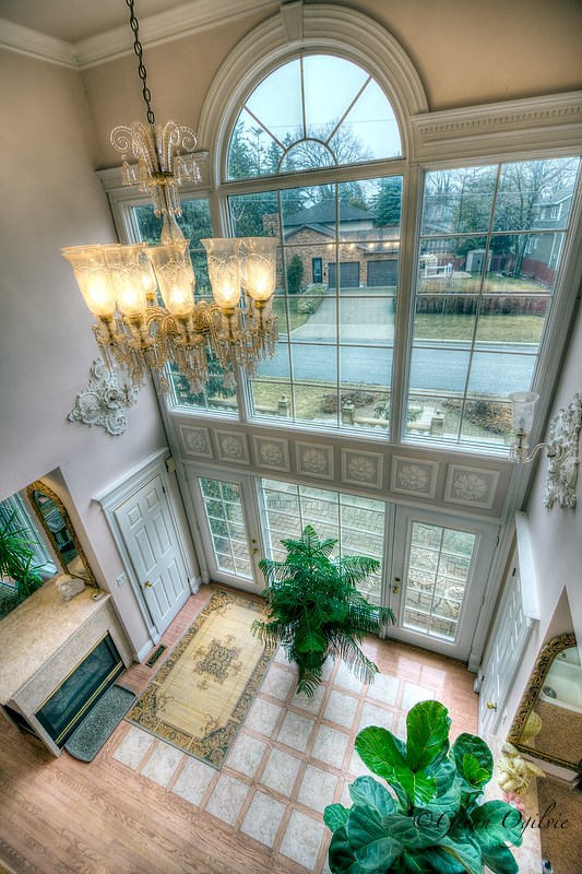 Looking down from the second floor to the home's east-facing doors. Natural wood and marble are also in keeping with the principles used in many ancient temples and buildings. Glenn Ogilvie 