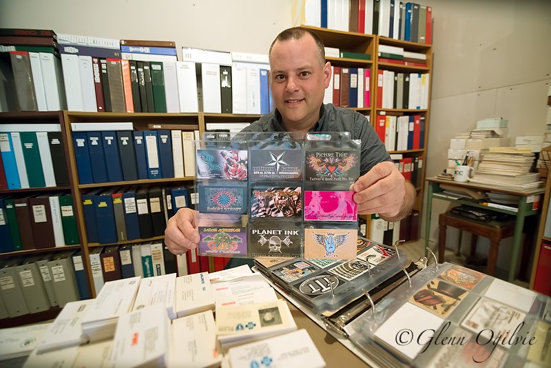 Ryan DeVries with his collection of business cards