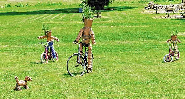 Flower power seems to drive this delightful family constructed from clay pots on Blackwell Sideroad. Glenn Ogilvie