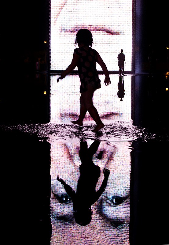 This image of a girl splashing in a reflecting pool at Millenium Park in downtown Chicago adds a three-dimensional feel to a two-dimensional photo. Doug Bisson
