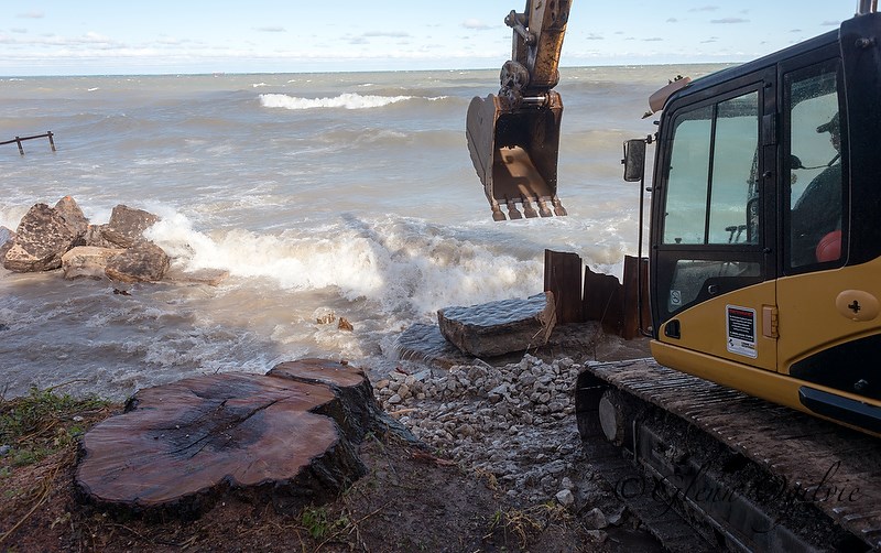 Heavy equipment and crews from Van Bree Drainage & Bulldozing work to shore up the breach with rock and stone. Glenn Ogilvie