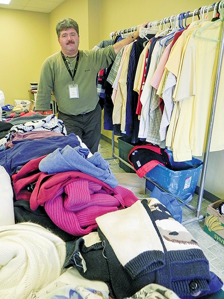 Myles Vanni, of the Inn of the Good Shepherd, checks a room at the Comfort Inn filled with clothing and toiletries donated to help evacuees of the Kenwick Place fire. Cathy Dobson