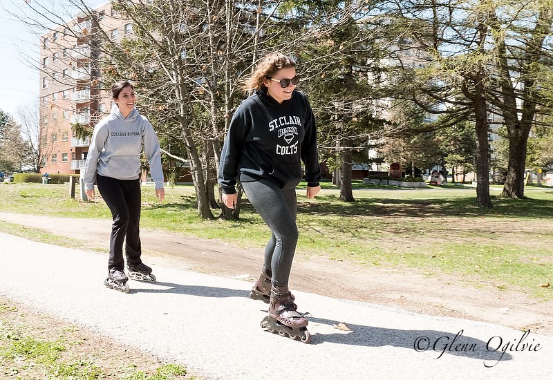 Warming temperatures and sunny skies were just right to entice college and university students to rediscover their home town following a year of studies. From left are; Hillary Kieran and sisters Chelsea and Paige Price. skating along the trail though Canatara Park.