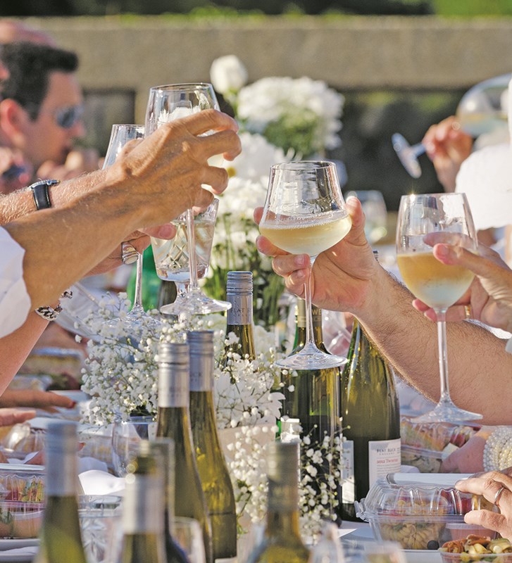 Diners raise a toast during Sarnia's first Simply White Dinner, which was held on the patio of a downtown waterfront highrise. Glenn Ogilvie file photo