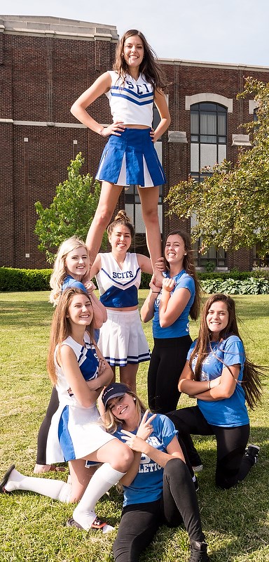 These SCITS students found some unused cheerleading costumes in a closet and employed them for a school portrait taken on "blue and white" day.     