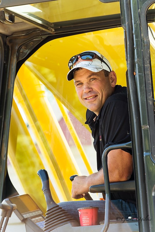 Contractor Pete Bakker smiles from the backhoe as he prepares to demolish Jamie Stewart's old home at 223 Beckwith St. in Corunna. Glenn Ogilvie 