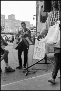 Photographer Larry Towell's upcoming show called Hot Food Free features this photo of a girl playing guitar in Rochester New York.