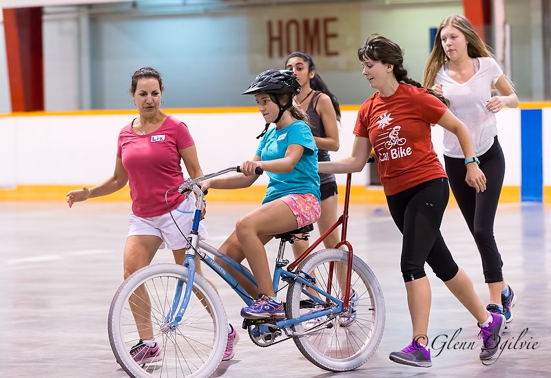 From left, Liz Oliveira, biker Sarah Wight, Persia Baha, iCan Shine instructor Manda Krimmer and Olivia Rodenhuis are nearly ready for Sarah to go solo. Glenn Ogilvie   