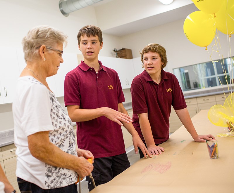 Grade 8 students Ronan Lewis, centre, and Anthony Smith show visitor Alice Vanderbyl around the new art and science room at Sarnia Christian School. Troy Shantz