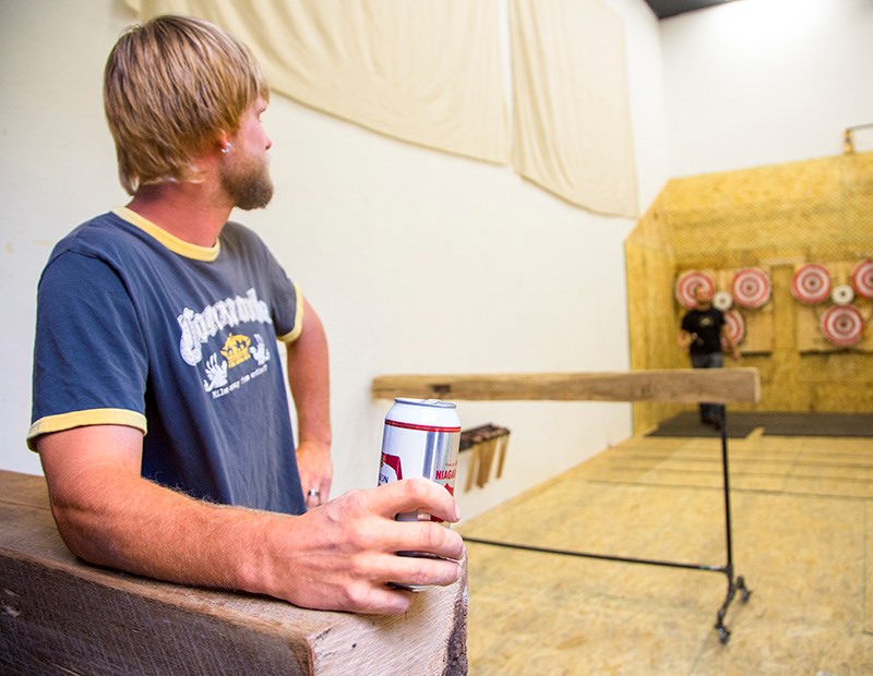 City resident Chris Van Veller pauses to sip a beer between axe throws at Valley Axe. Troy Shantz