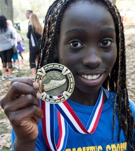 Ann Mabel Wambulwa, of Bright's Grove Public, shows off her third place medal in the 11-year-old division. Glenn Ogilvie 