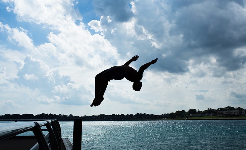 Austin Wright, 20, does a backflip into the St. Clair River beneath the Blue Water Bridge in Point Edward. Wright, a strong swimmer, was involved in a dramatic rescue in September in which he saved the life of a 16-year-old girl as she was being pulled under in the strong current. Troy Shantz