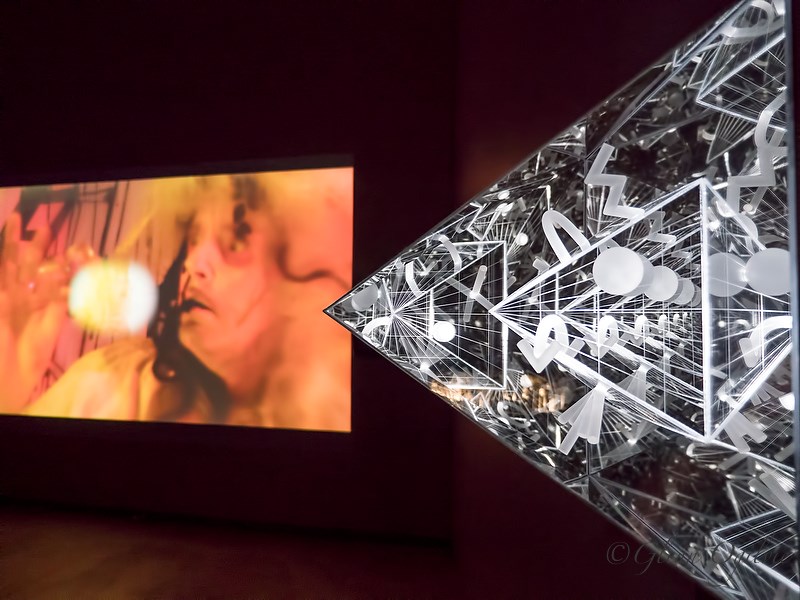 IIn Shadow of the Millennium was an exhibition rooted in ancient knowledge, myths and superstitions at the Judith & Norman Alix Art Gallery. Seen here is the side view of a pyramid made of plastic, wood and electrical components by Camille Jodoin-Eng. In the background is an eight-minute video projection by Jessica Mensch and Emily Pelstring. Glenn Ogilvie