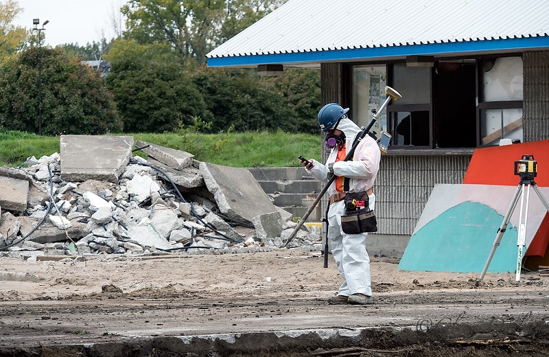 The remediation of Centennial Park was a hot-button issue in 2016, with on-going delays and a price tag that ballooned to $12 million. Here, a fully-suited worker wearing a breathing respirator as protection from air-borne contaminants stands beside a pile of concrete rubble in Centennial Park in October. Glenn Ogilvie 