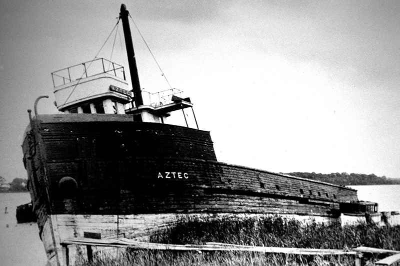 The Aztec as it lay abandoned on the edge of Sarnia Bay in the 1920s. Built at Marine City, Michigan, in 1889, she suffered the destruction of her stern half to a fire there in May, 1923. The ship was patched up enough to tow her to the nearest "boneyard" for old ships, namely Sarnia Bay, where the vessel was abandoned until being removed in 1936. The Aztec had to be dynamited out of the bay, and the many, huge pieces of her wooden hull were placed on board the raised Province, towed out into Lake Huron, and sunk in the late summer  of 1936.  Kohl-Forsberg Archives