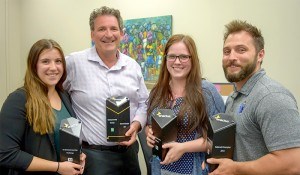 Students Megan Rizzo, left, and Courtney Neilson hold some of the trophies won by Lambton College's Enactus team with Jon Milos, entrepreneurship director, second from left, and faculty advisor Matthew Hutchinson. Cathy Dobson