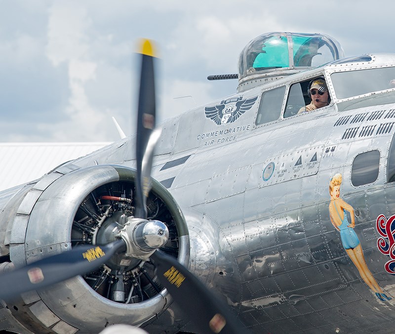 Sentimental Journey crewmember David Oliver watches as one of its 1,200 horsepower engines roars to life. The vintage bomber can remain in the air for seven and a half hours while consuming 1,400 gallons of fuel. Troy Shantz