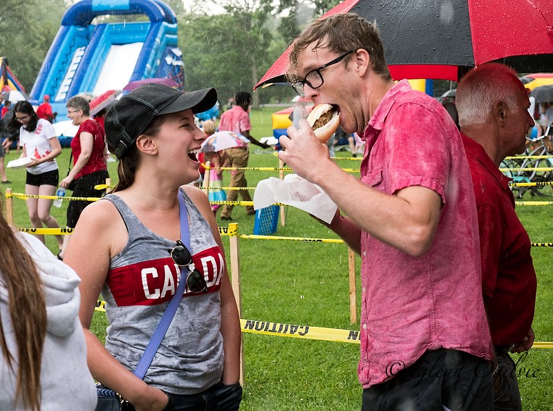 Julia Iacovella has a laugh while Owen Allison tucks into a souvlaki after being drenched in a food line-up at Canatara Park. Glenn Ogilvie 