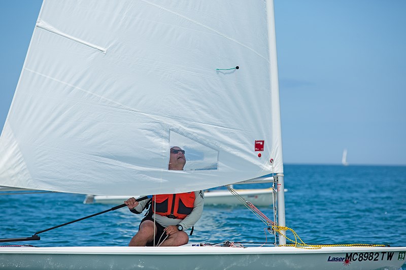 Competitor Adam Ovidiu inspects his sail in light winds. Troy Shantz