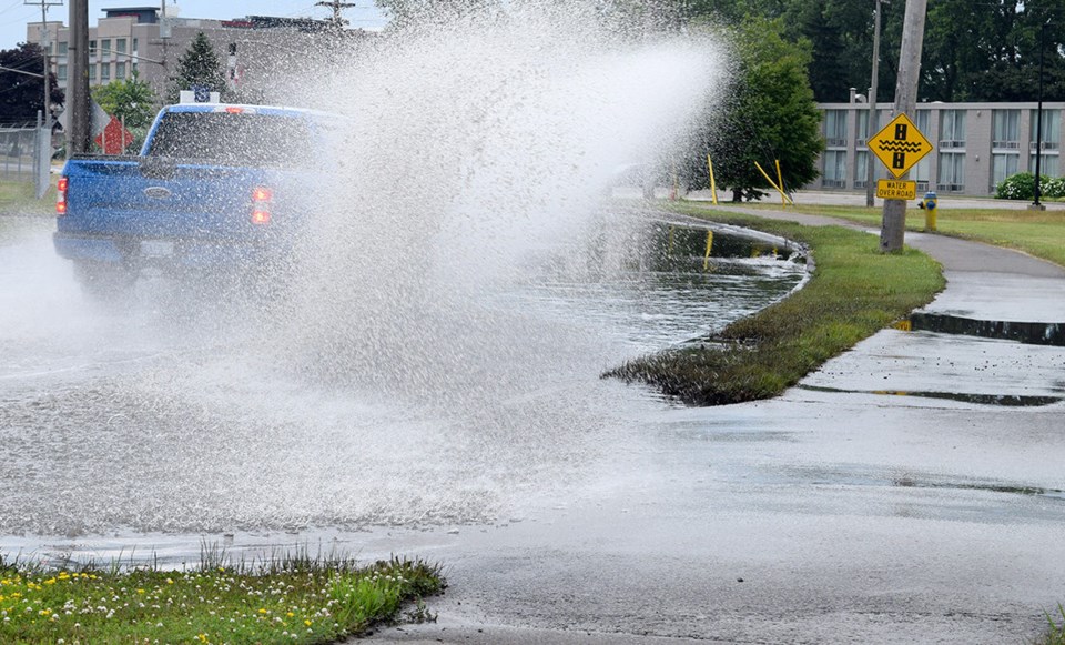 A car splashes through the flood zone near Bridgeview Marina.Cathy Dobson
